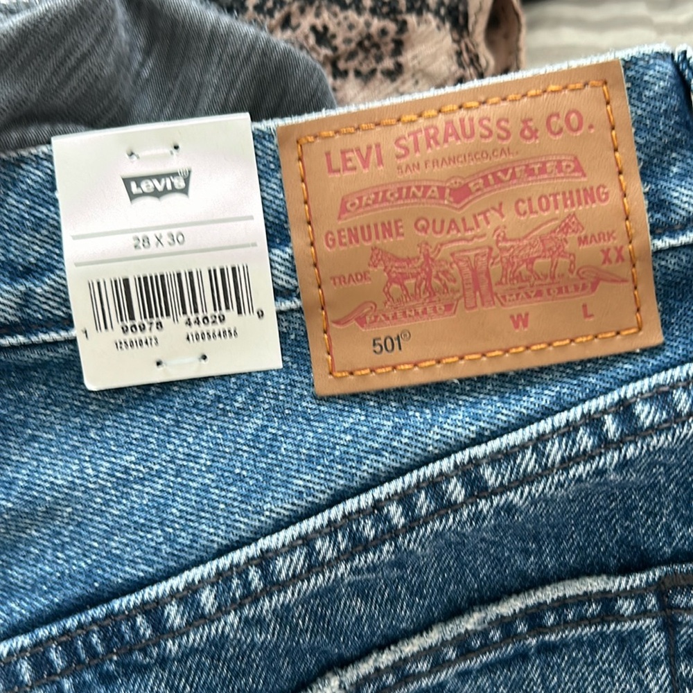Levi’s 501 blue jeans, button fly , hole in left leg, new with tags
